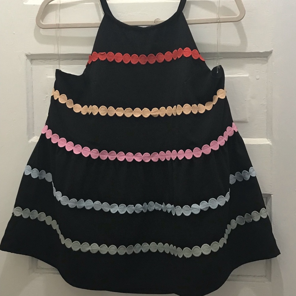 Black peplum top with color dot detail